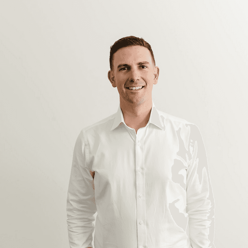 Nick Roebuck is an associate at Habitat Planning. He is pictured wearing a white business shirt and is smiling at the camera.